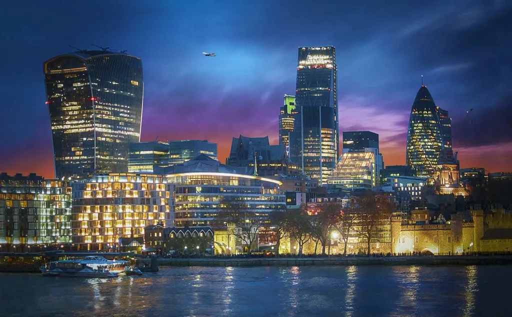 The City of London skyline and the Tower of London at dusk, seen across the River Thames