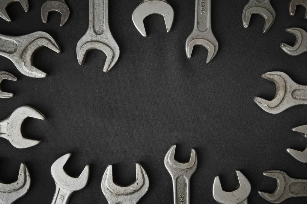 Spanners of different sizes laid out on a dark cloth, representing website maintenance